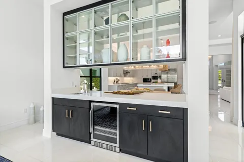 a bedroom with a bed tv and a large window