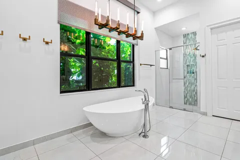 a bathroom with a granite countertop sink a toilet and shower