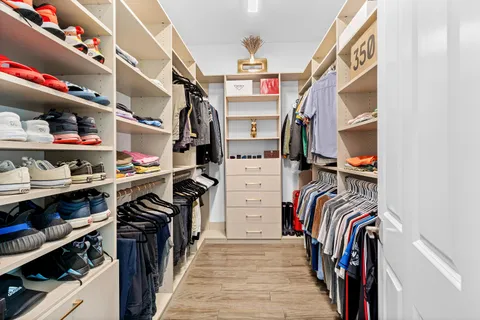 a bathroom with a granite countertop sink and a toilet