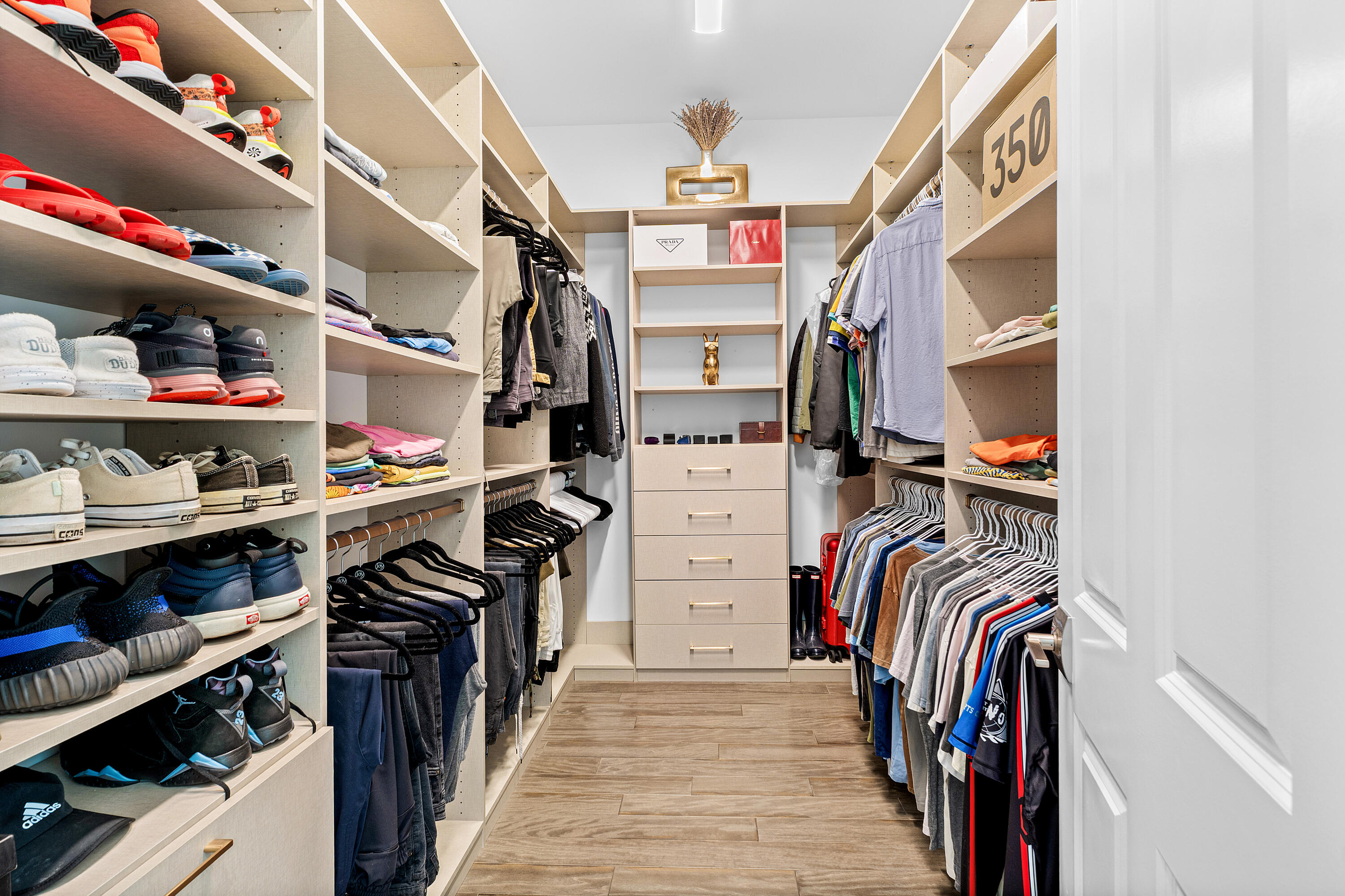 9594 Vescovato Way Boca Raton, FL 33496 - Photo 25 of 67 a view of walk in closet with clothes and shoes
