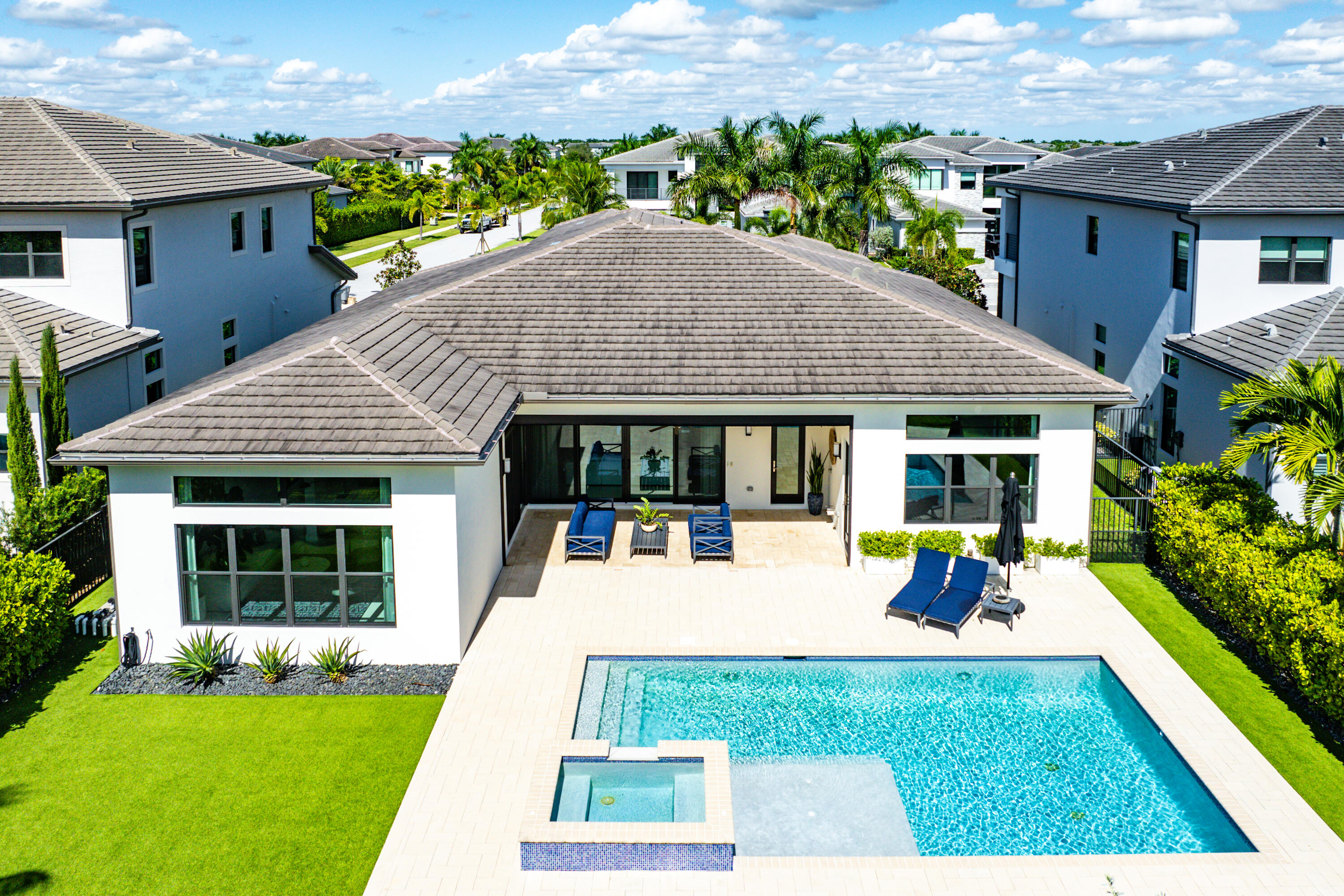 9594 Vescovato Way Boca Raton, FL 33496 - Photo 36 of 67 a view of a house with swimming pool and a yard