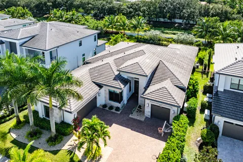 an aerial view of a residential houses with outdoor space and swimming pool
