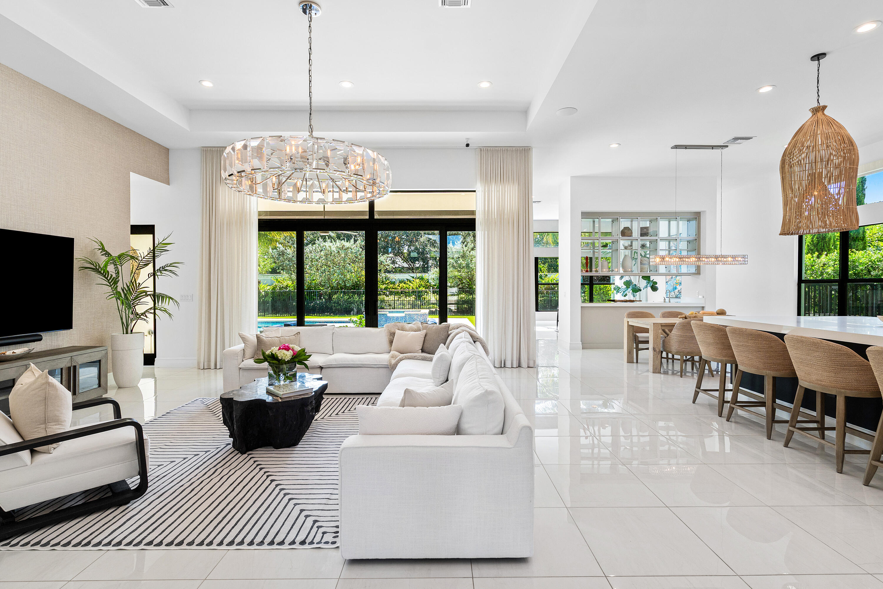 9594 Vescovato Way Boca Raton, FL 33496 - Photo 6 of 67 a living room with furniture a chandelier and a large window