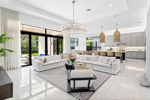 a living room with furniture and a chandelier