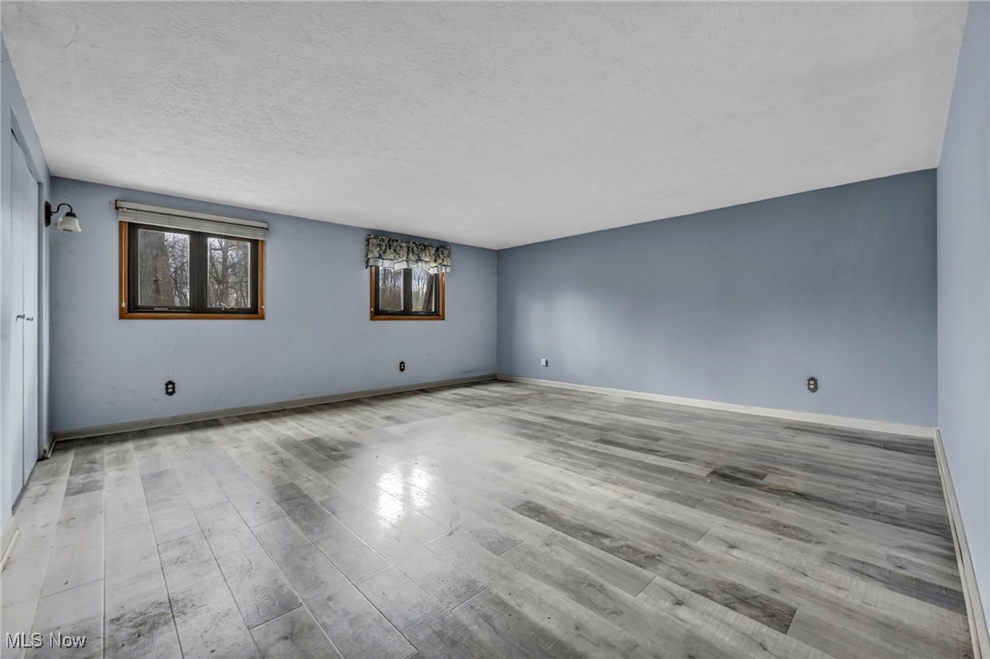 2680 Orchard Ext Road Wickliffe, OH 44092 - Photo 25 of 30 Empty room featuring baseboards, a textured ceiling, and wood finished floors