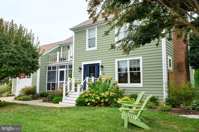 a view of a house with a yard and sitting area