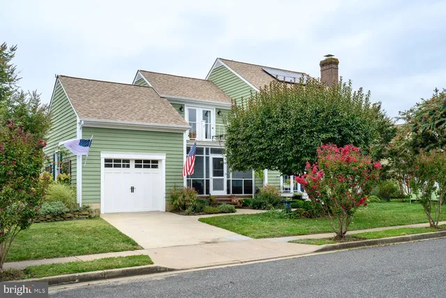 a front view of a house with a yard and a garage
