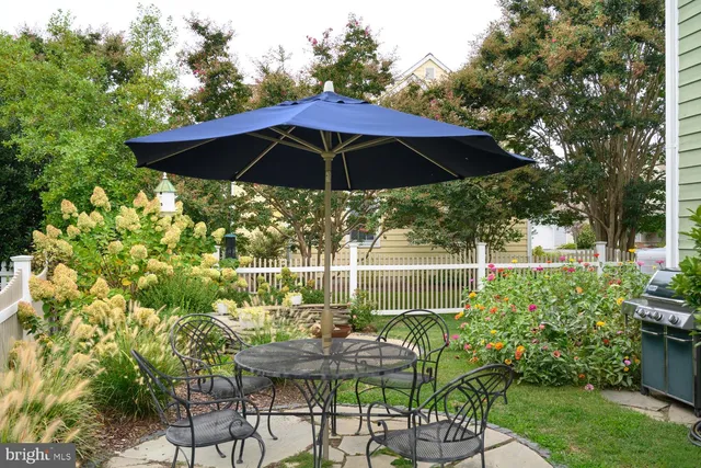 a view of yard with furniture and umbrella