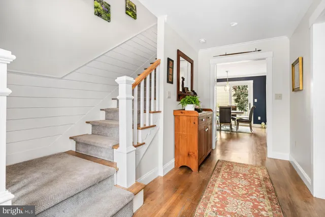 a view of entryway and hall with wooden floor