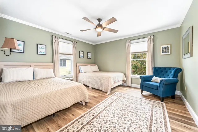 a spacious bedroom with a bed and a large window