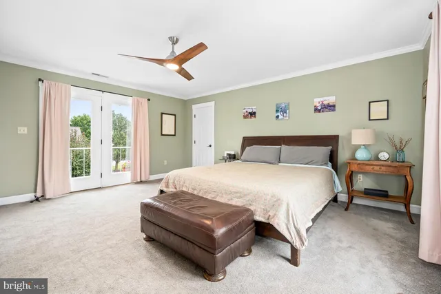 a spacious bedroom with a bed and a flat screen tv