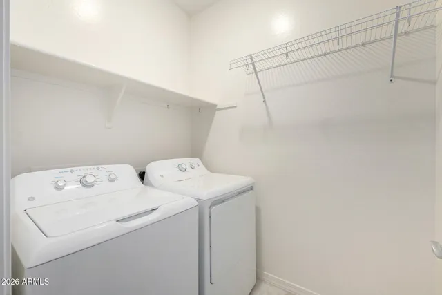a view of a livingroom with wooden floor and a ceiling fan