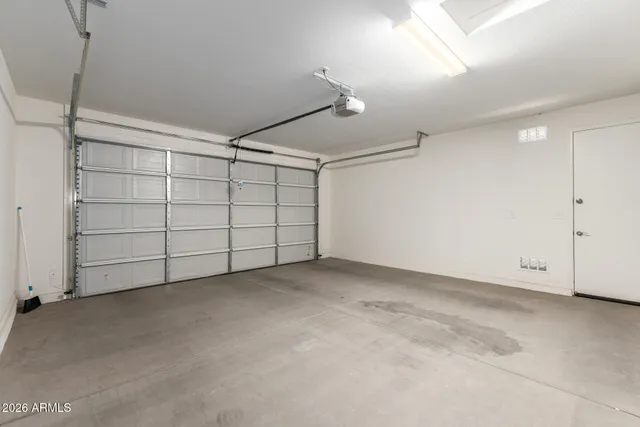 an empty room with windows and ceiling fan view