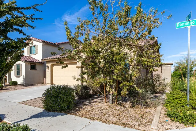a kitchen with stainless steel appliances granite countertop a sink a stove a refrigerator cabinets and wooden floor