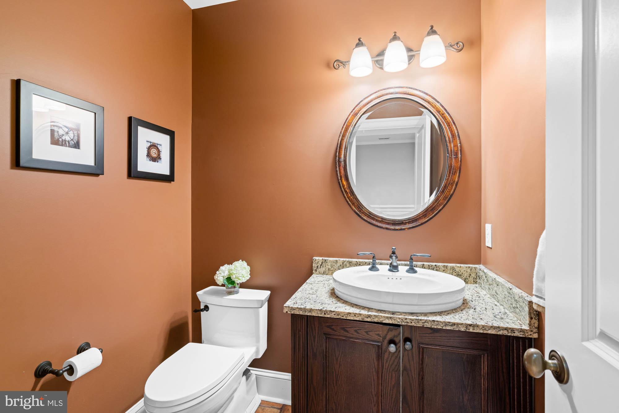 2215 King Place Northwest Washington, DC 20007 - Photo 47 of 58 a bathroom with a granite countertop toilet sink and mirror