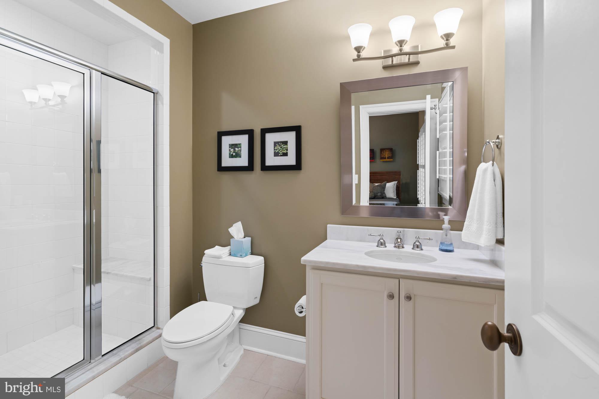 2215 King Place Northwest Washington, DC 20007 - Photo 49 of 58 a bathroom with a toilet sink vanity and mirror