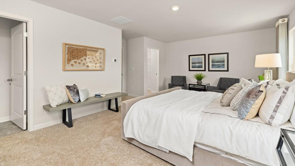 3873 Donetta Drive Atlanta, GA 30349 - Photo 17 of 50 a bedroom with a bed and a couch