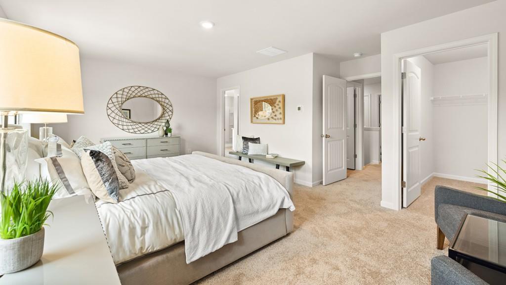 3873 Donetta Drive Atlanta, GA 30349 - Photo 19 of 50 a bedroom with a bed and a potted plant