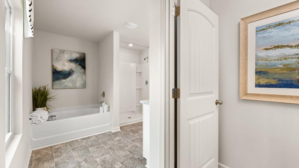 3873 Donetta Drive Atlanta, GA 30349 - Photo 21 of 50 a bathroom with a glass shower door