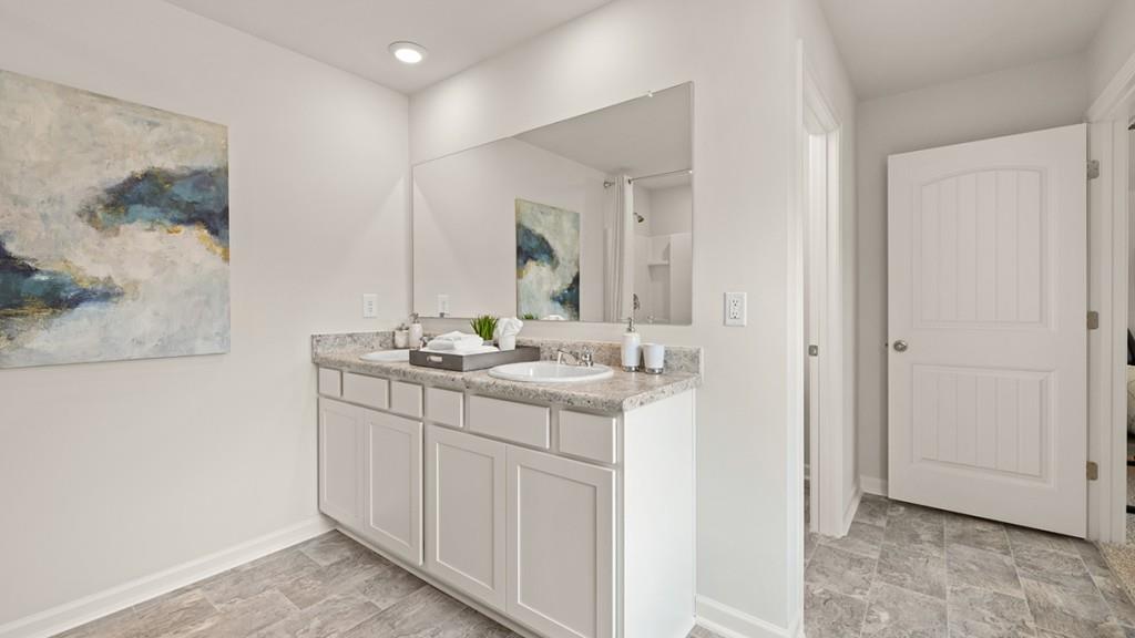 3873 Donetta Drive Atlanta, GA 30349 - Photo 22 of 50 a bathroom with a sink and a mirror