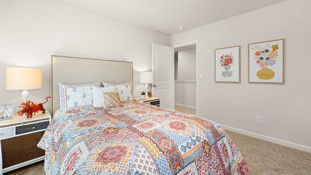 3873 Donetta Drive Atlanta, GA 30349 - Photo 29 of 50 a bedroom with a bed and painting on the wall