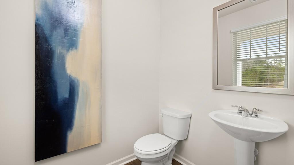 3873 Donetta Drive Atlanta, GA 30349 - Photo 38 of 50 a bathroom with a sink toilet and a mirror