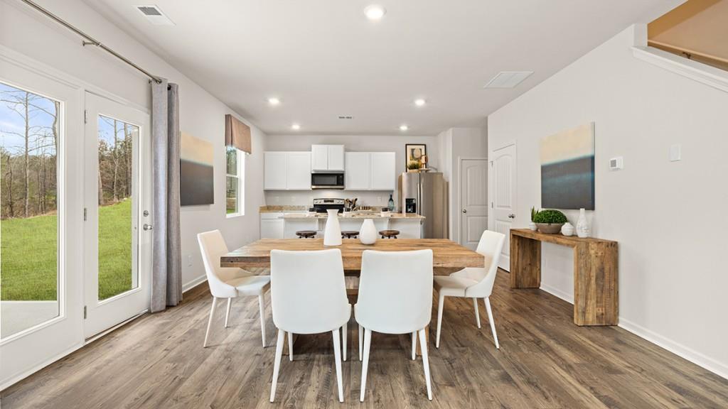 3873 Donetta Drive Atlanta, GA 30349 - Photo 10 of 50 a view of a dining room with furniture window and wooden floor