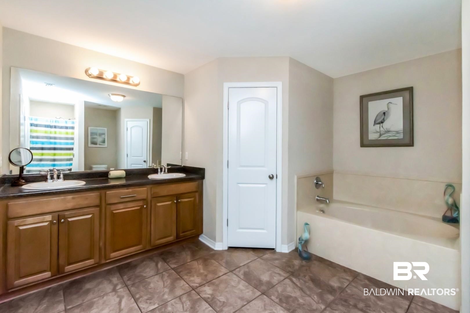 11528 Mocking Bird Lane Fairhope, AL 36532 - Photo 19 of 45 Bathroom with double vanity, a bath, and dark tile patterned flooring