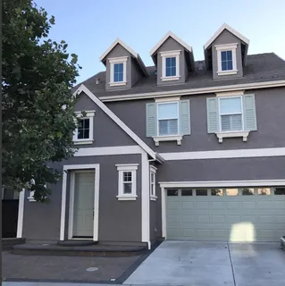 a view of a white building with large windows
