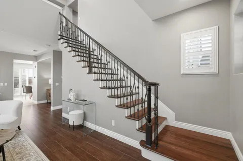 a view of entryway and hall with wooden floor