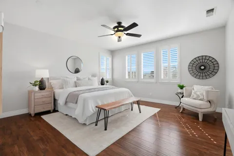 a bedroom with a bed and a chandelier
