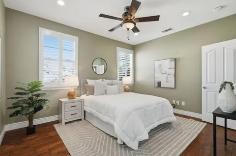 a bedroom with a large bed and a chandelier