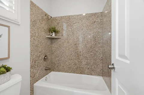 a bathroom with a bathtub and toilet