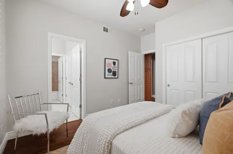 a bedroom with a bed and a chandelier