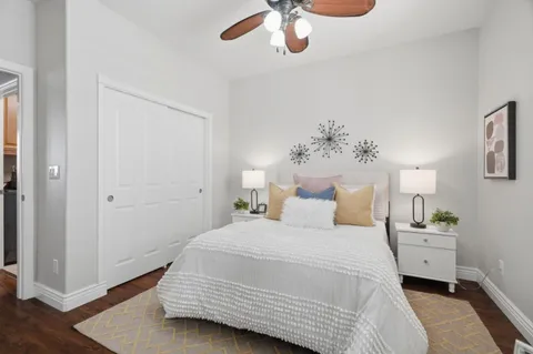 a bedroom with a bed and a chandelier
