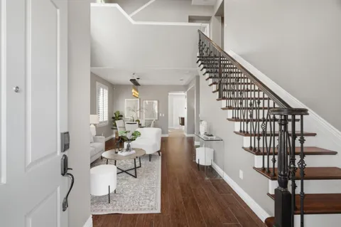 a very nice looking room with wooden floor and furniture