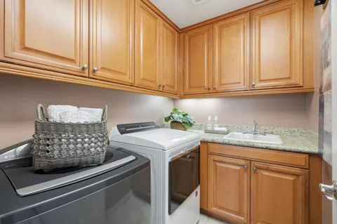 a kitchen with granite countertop a sink and dishwasher stove top oven