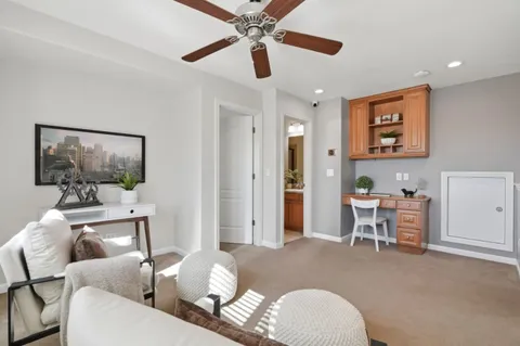 a living room with furniture and a painting on the wall