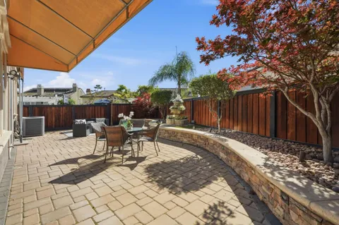 a view of a patio with a table and chairs
