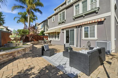 a view of a patio with couches and potted plants