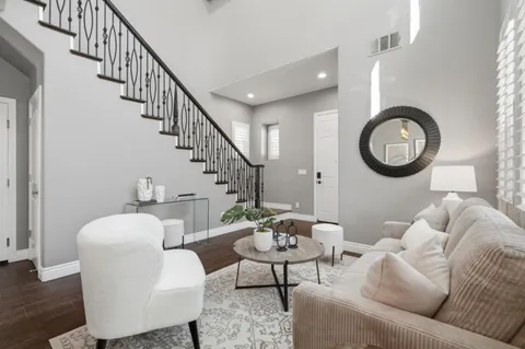 a living room with furniture a rug and a window