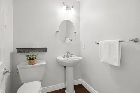 a bathroom with a sink mirror and toilet