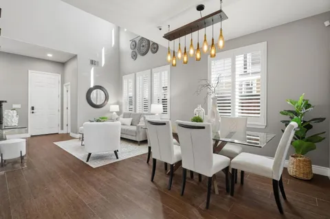 a living room with furniture a window and wooden floor