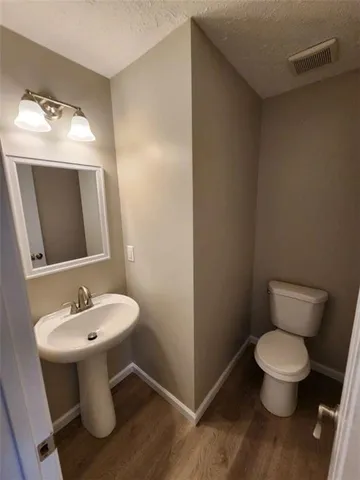 a white toilet sitting next to a bathroom sink