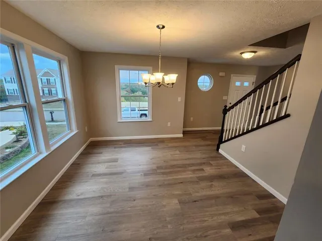 a view of a room with wooden floor and windows