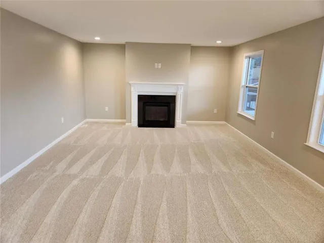 a view of empty room with a fireplace
