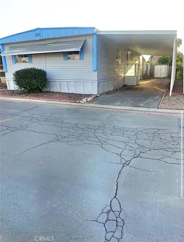 a view of a house with a patio and a yard