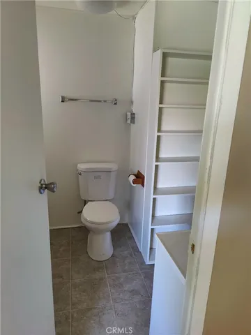 a white toilet sitting next to a sink