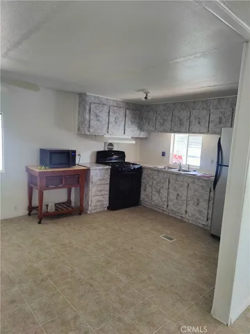 a view of kitchen with furniture and window
