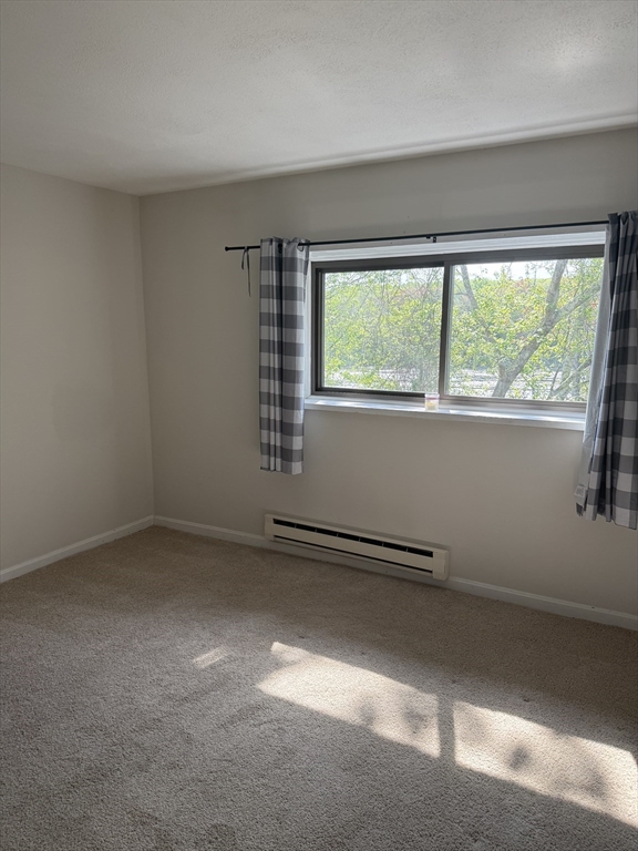 310 Codman Hill Road, Unit 34D Boxborough, MA 01719 - Photo 12 of 17 an empty room with a window